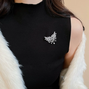 Detail of vintage butterfly brooch with pearls and zircon on a black turtleneck sweater