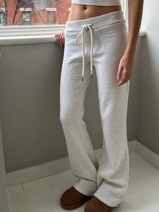 Detail of light grey yoga pants with adjustable drawstring waist and relaxed fit design