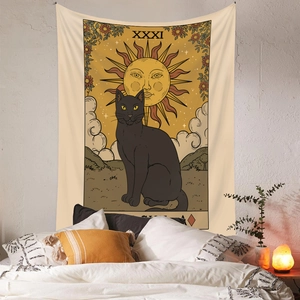 Bohemian black cat tarot tapestry with sun motif hanging in cozy bedroom setting