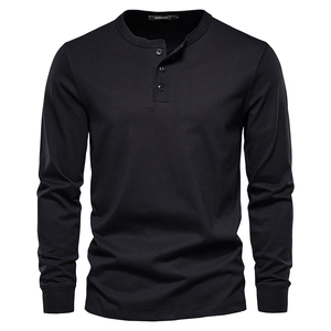 Detail shot of black long-sleeve Henley shirt featuring a three-button placket and knit texture