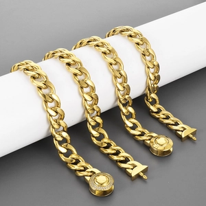 Close-up of gold Cuban link necklace with diamond-encrusted round buckle and T-bar clasp