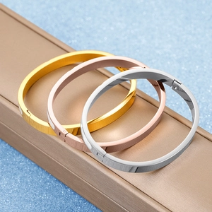 Minimalist stainless steel oval bangles in gold, silver, and rose gold finishes