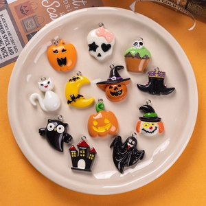 Halloween resin pendants set featuring pumpkins, ghosts, and black cats on a beige plate