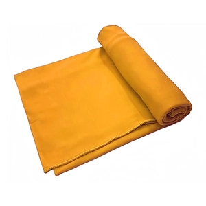 Detail of yellow soft milk silk headscarf fabric texture and vibrant plain solid color