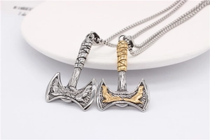 Macro view of Viking double eagle axes in silver and gold-tone titanium steel