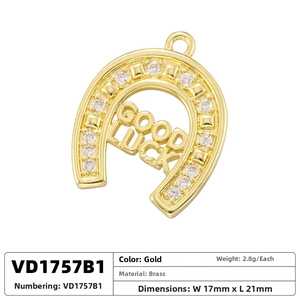 Detailed view of horse shoe pendant in gold with Good Luck engraving and zircons