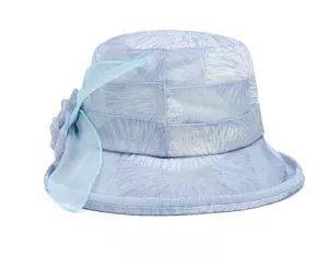 Detail view showing the back of a light blue sun hat with mesh bow and floral texture