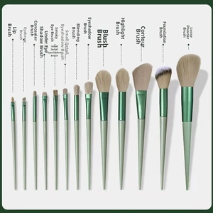 Detail view of 13-piece makeup brush set with green handles and soft beige bristles