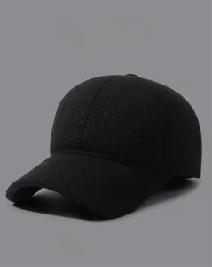 Detail of winter baseball cap with ear flaps and metallic MR side logo decoration