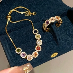 Detail view of 14k gold plated rainbow gemstone jewelry set with rings and bracelets