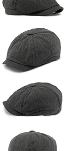Macro detail of dark grey herringbone newsboy cap showing thick wool blend texture