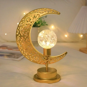Golden crescent moon table lamp with crystal ball and warm LED lights in bedroom