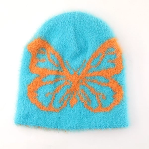 Vibrant blue plush knit beanie with bold orange butterfly pattern for winter warmth