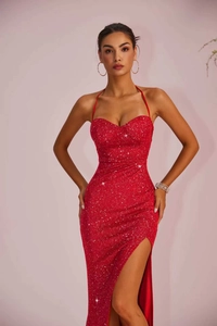 Detail of red sequin fabric with sexy high slit design on an elegant evening maxi dress