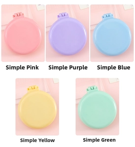 Collage of colorful portable folding hairbrushes with makeup mirrors in pastel tones