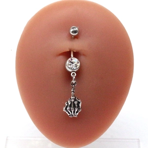 Skeleton hand belly button ring with clear cubic zirconia on a silicone model body