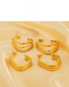 Detailed view of layered 18K gold plated earrings with twisted rope texture on silk