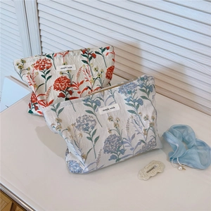 Detail of floral canvas pouches with simple wish label and premium metal zipper closure