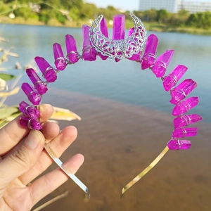 Detailed view of handmade purple crystal moon crown with silver wire wrapping