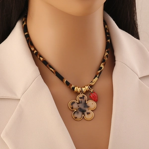 Retro leopard print flower pendant necklace with strawberry charm on a model
