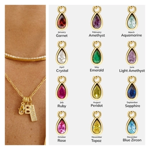 Detail view of 18K gold plated birthstone charms with water drop shape and model lifestyle