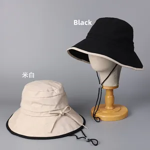 Detail of cotton linen sun hats featuring adjustable windproof ropes and contrast brim trim