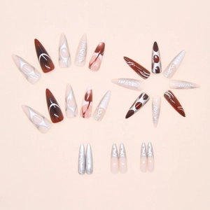 Macro detail of long stiletto press-on nails with silver metal relief and cat-eye patterns