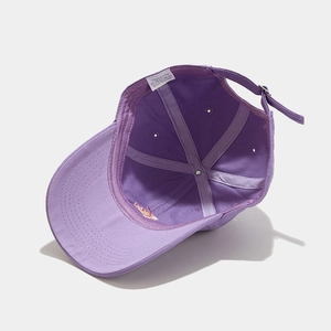 Detail view of cotton baseball cap interior structure with sweatband and wash label