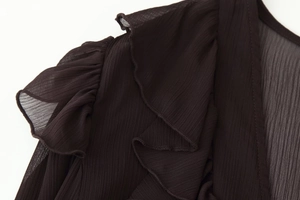 Detail of layered ruffle design and textured chiffon fabric on the dark midi dress