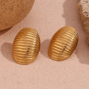 Close-up of gold-plated stainless steel oval earrings with elegant striped texture