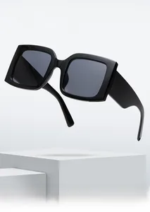 Detail shot of large black square frame sunglasses with stylish dark grey lenses