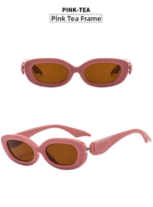 Detail view of oval sunglasses featuring pink frames, tea lenses, and integrated nose pads