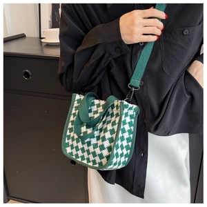 Green and white houndstooth canvas tote bag with detachable shoulder strap shown on a model