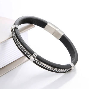 Detail of black leather bracelet with silver woven metal and brushed magnetic clasp