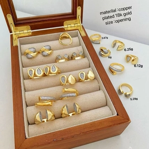 18k gold plated copper open rings with droplet and heart shapes on beige velvet