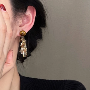 Elegant tiger eye stone earrings with golden layered leaf tassels in a retro fashion style