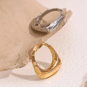 Macro detail of textured gold and silver rectangular rings with molten metal finish