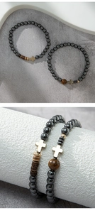 Detail of hematite bead bracelets with gold cross charms on a white display