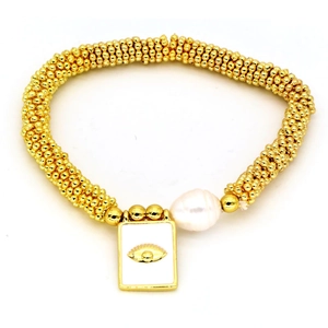 Detail of bohemian gold bead bracelet with baroque pearl and evil eye enamel charm