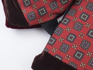 Detail of velvet trimmed puffer vest featuring retro floral patterns and reinforced webbing