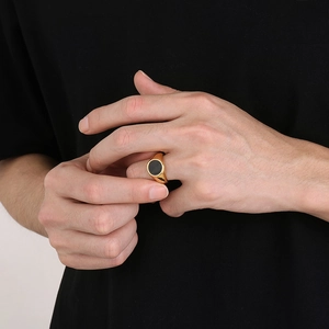 Polished gold titanium steel signet ring for men featuring a black circular enamel inlay