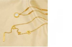 Détail du collier en acier doré 18k avec lettres LOVE et pendentif en nacre blanche