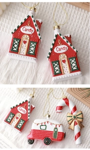 Detail of Christmas tree ornaments including a candy house, red camper, and candy cane