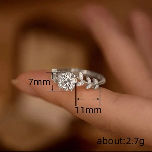 Elegant laurel branch silver ring with 7mm round cubic zirconia on female finger