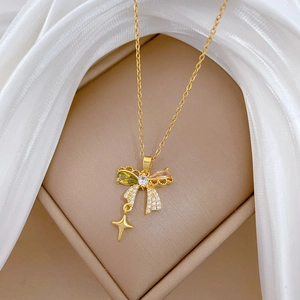 Detail of butterfly necklace with multicolor zircons and star pendant on silk