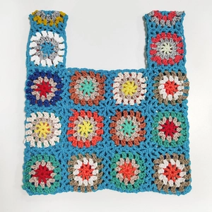 Close-up of colorful handmade crochet tote bag texture with intricate knit patterns