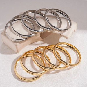 Minimalist 5-piece stackable geometric metal bangles in polished gold and silver finishes