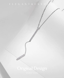 Macro shot of silver S925 Y-shaped necklace with elegant diamond-encrusted bar pendants