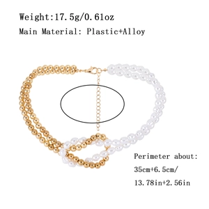 Double-layer gold bead and faux pearl necklace with knot detail on white background