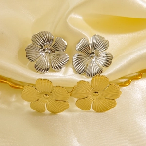 Minimalist stainless steel flower stud earrings in gold and silver plating on silk fabric